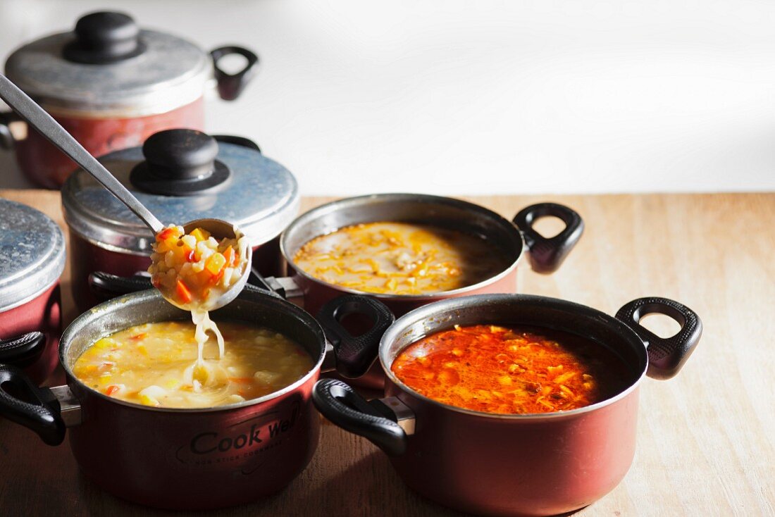 Various vegetable soups in pots