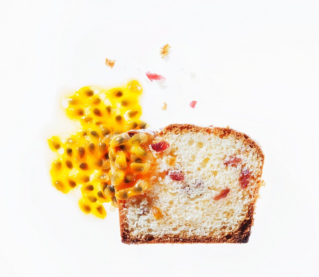 A slice of ricotta cake with cranberries, oranges and passionfruit sauce