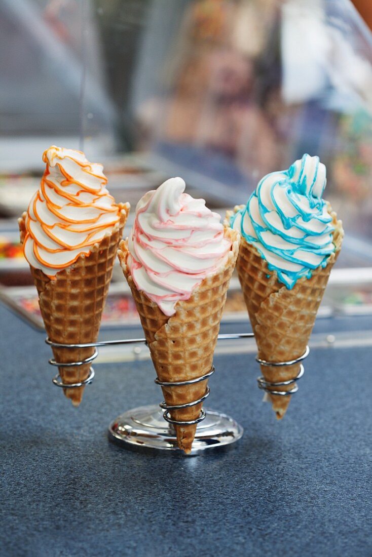 Three cones of soft serve ice cream