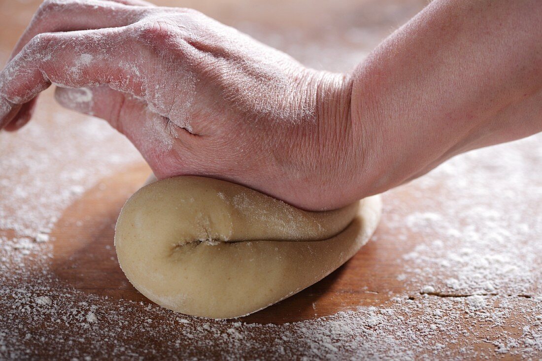 Hands kneading pastry