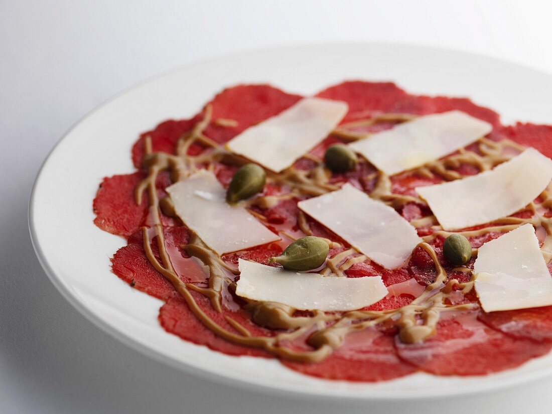 Salami carpaccio with cheese and capers