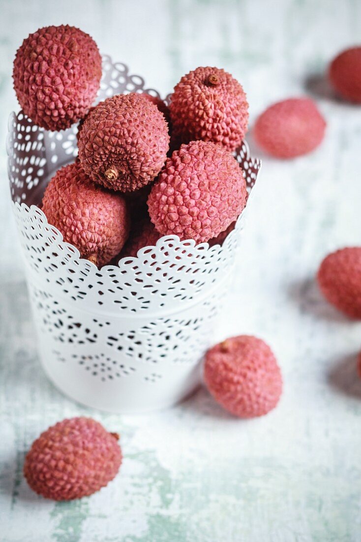 Lychees in a white pot and next to it