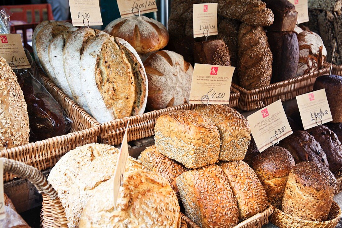 Various loaves of rustic bread on a market stall