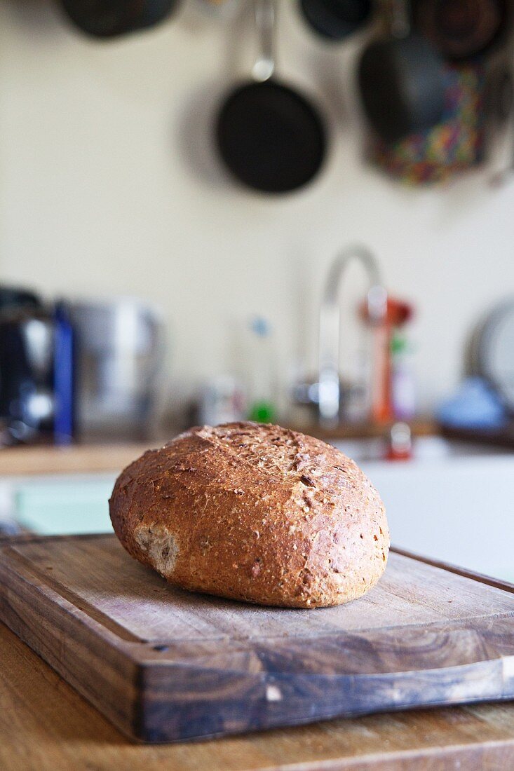 A loaf of country bread in a kitchen