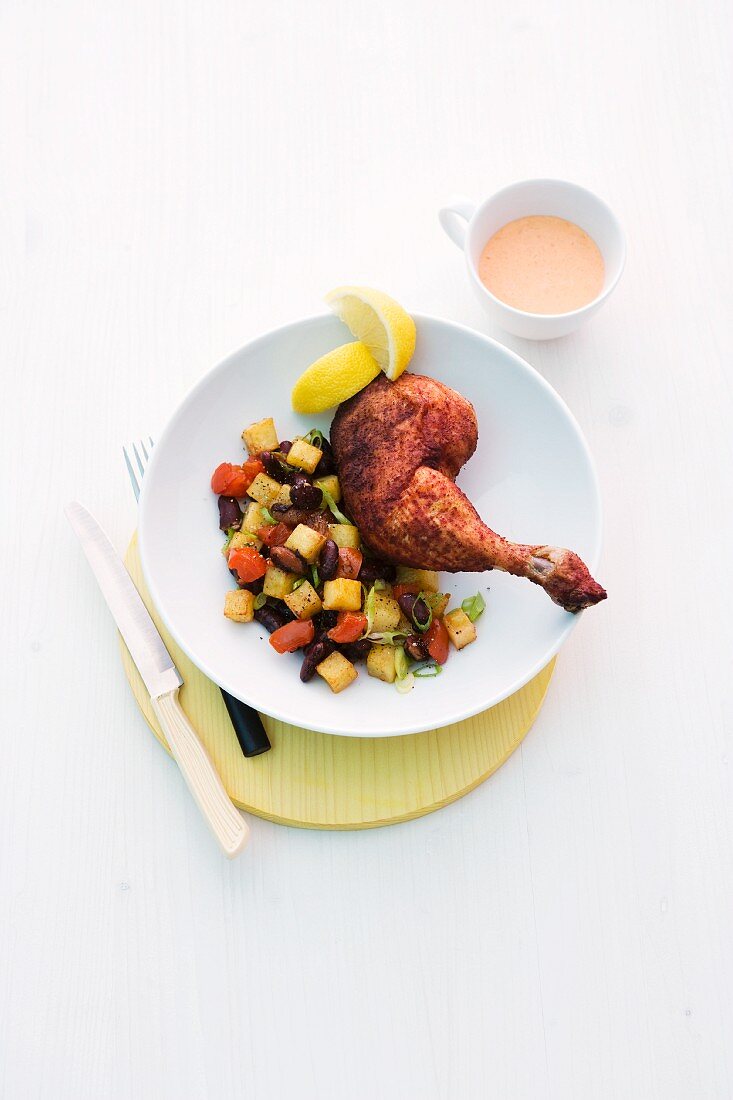 Chicken legs with fried potatoes, kidney beans and a dip