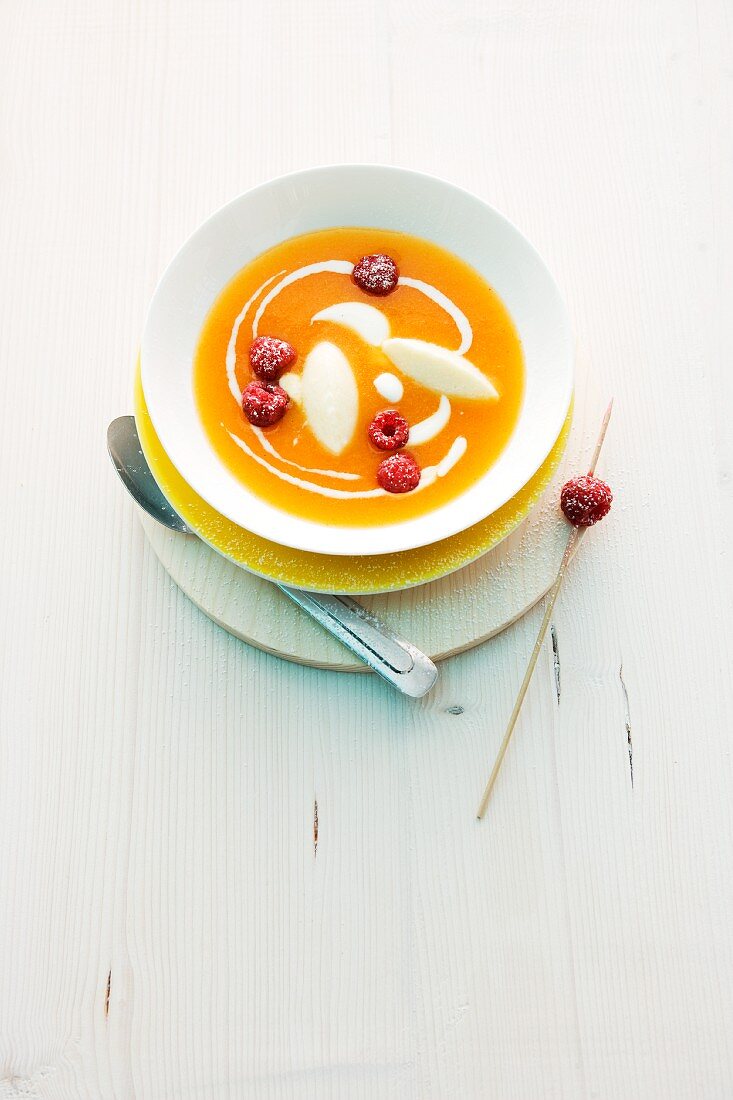 Apricot soup with semolina dumplings and raspberries