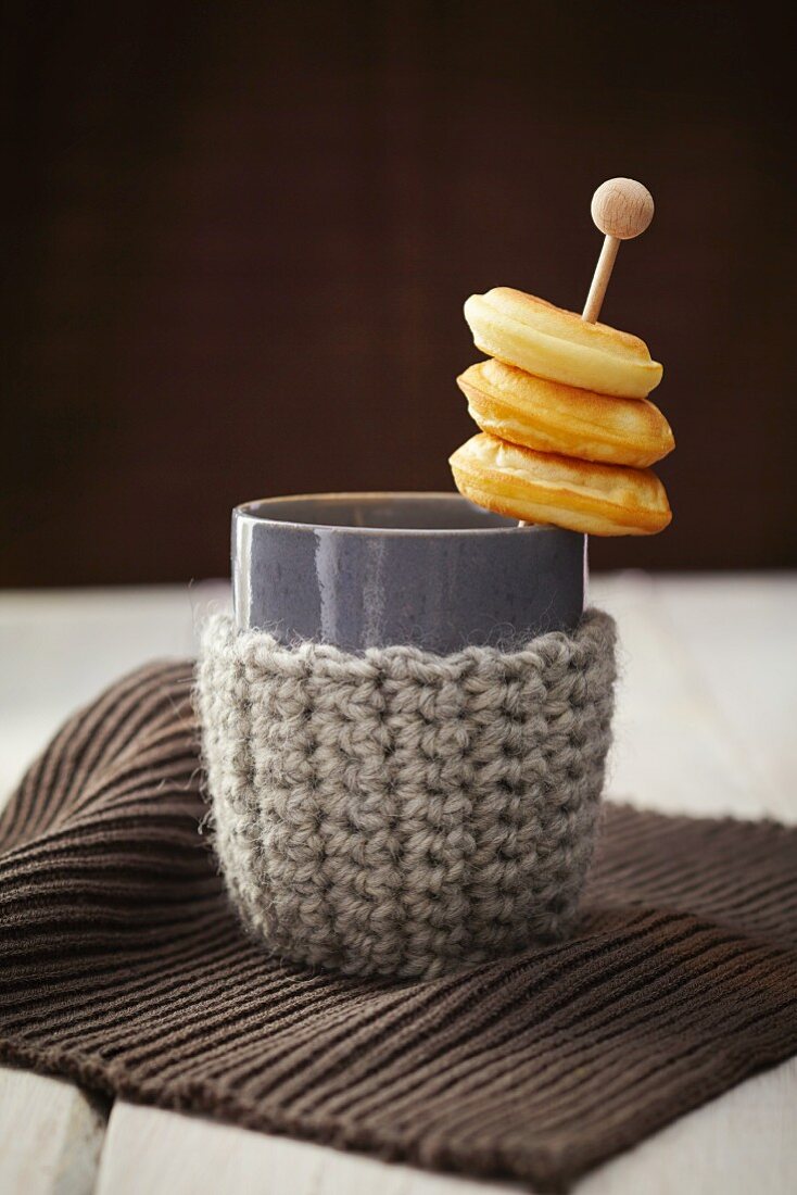 Doughnuts on a stick in a cup with a knitted holder