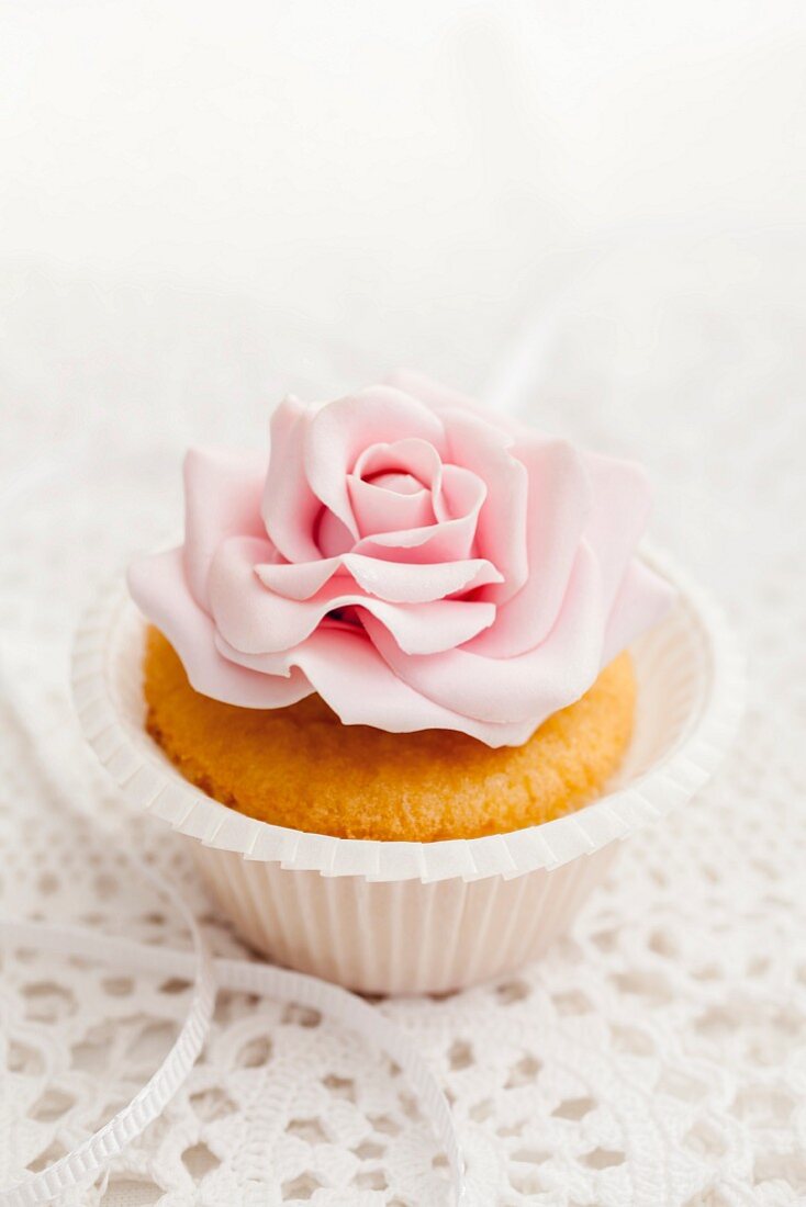 A cupcake decorated with a sugar flower