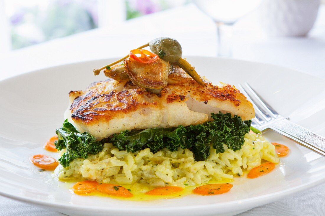 Cod fillet with green kale on lemon risotto rice