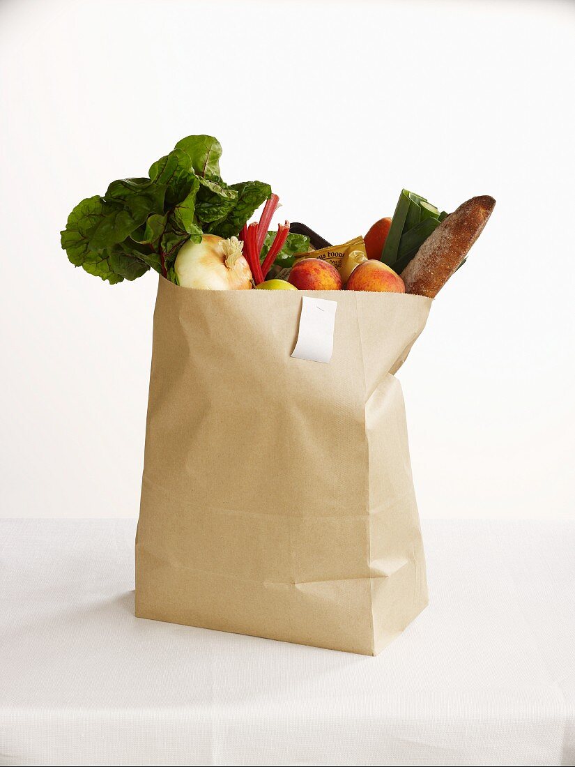 Fresh fruit and vegetables in a paper bag