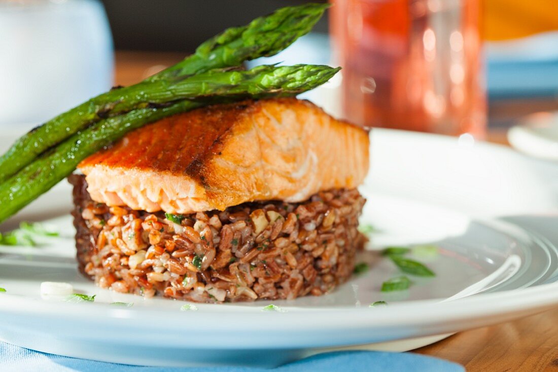 Salmon fillet with green asparagus on a bed of rice
