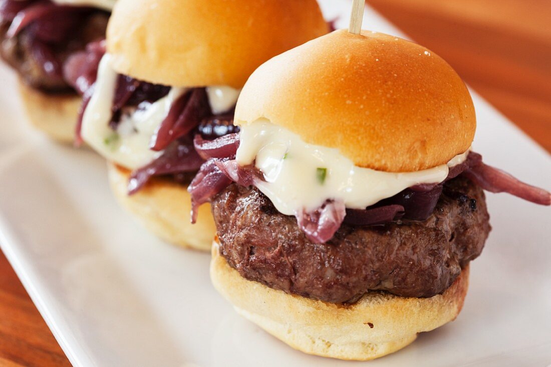 Mini cheese burgers with red onions