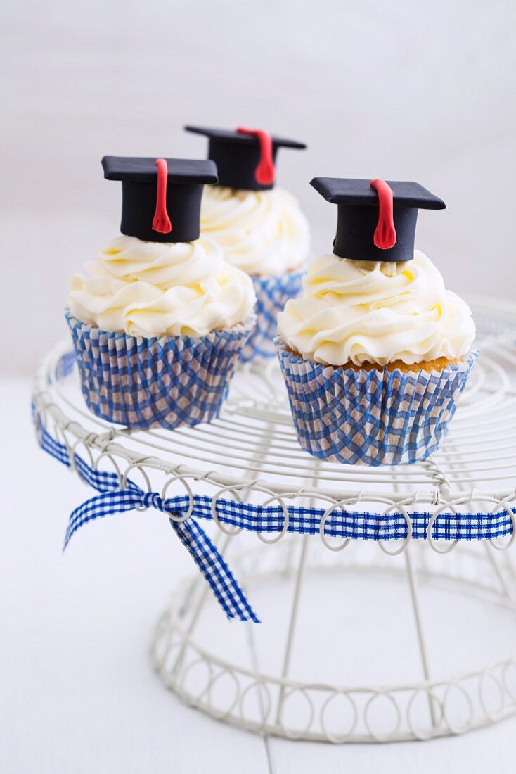 Cupcakes decorated with vanilla cream and mortar boards