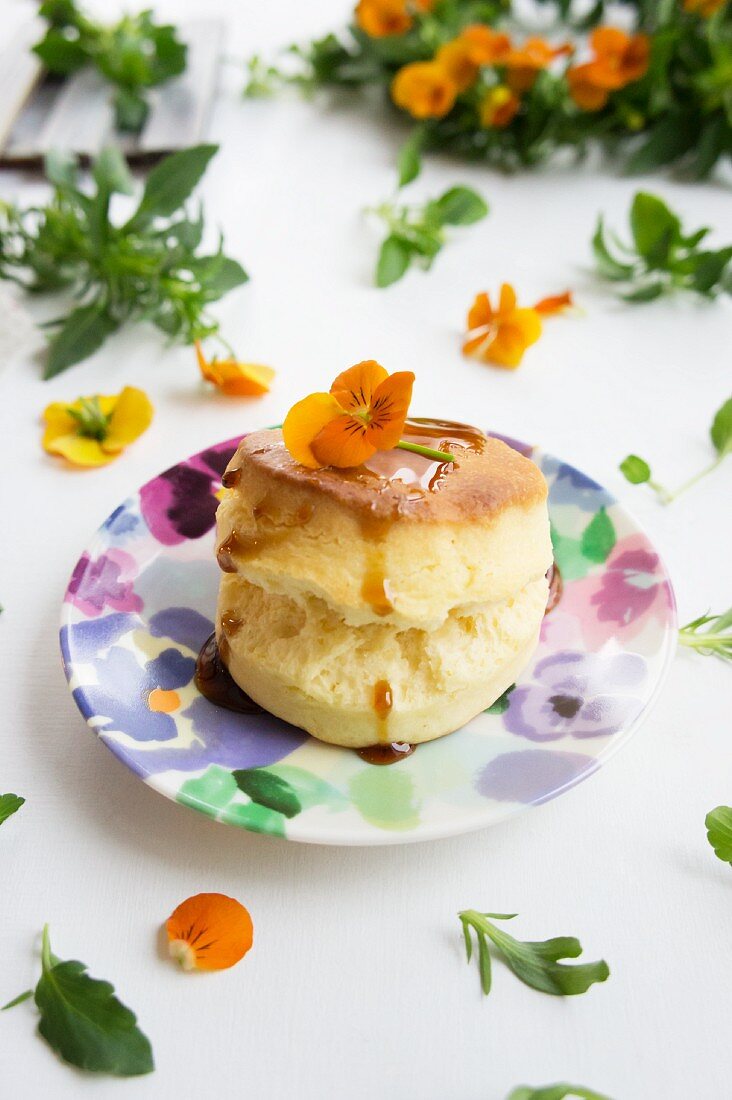 A scone with sugar syrup and tufted pansies