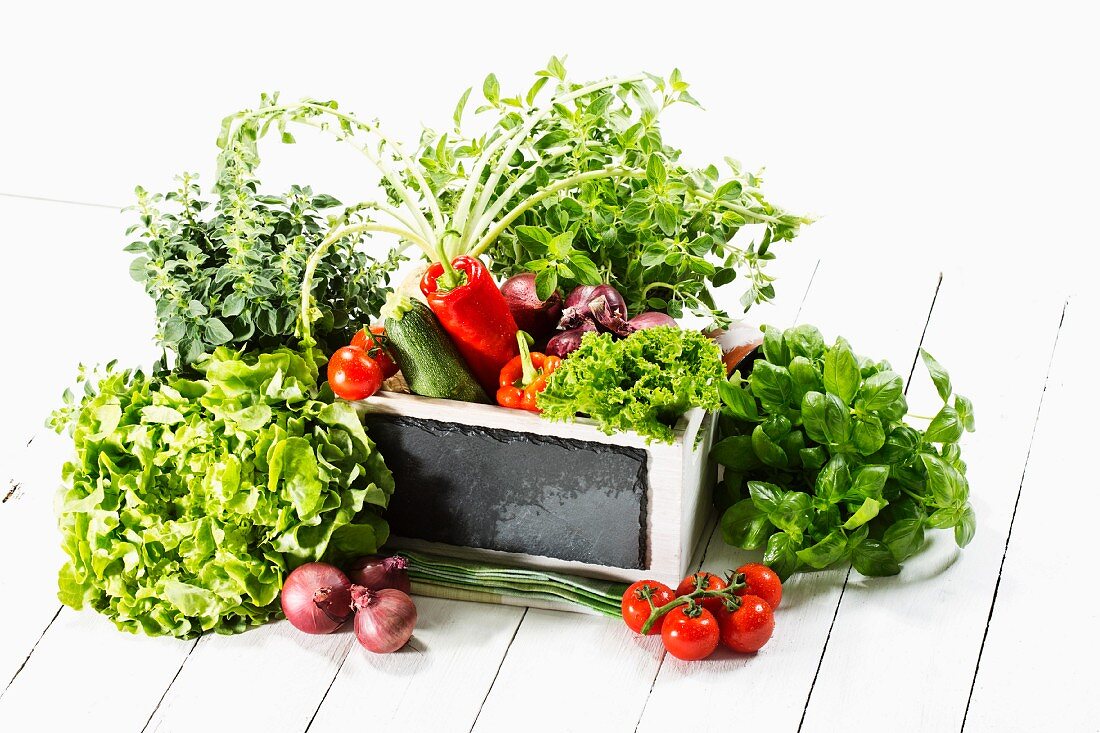 An arrangement of fresh vegetables and herbs