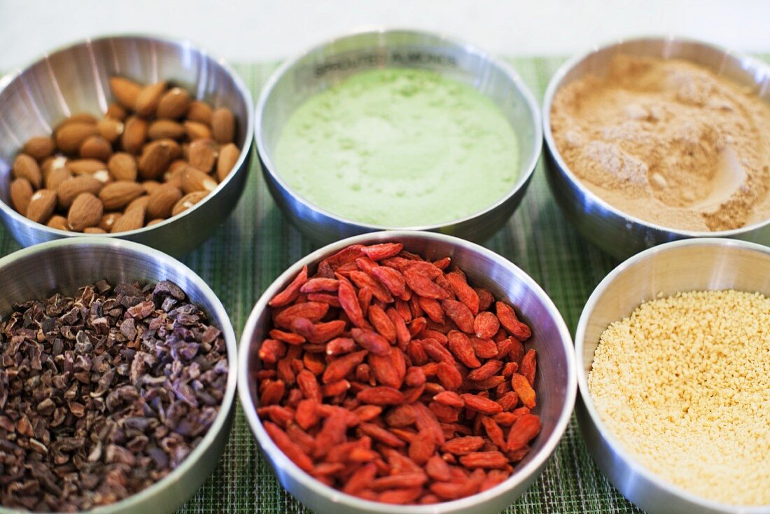 Bowls of various ingredients (almonds, spices, goji berries, couscous)