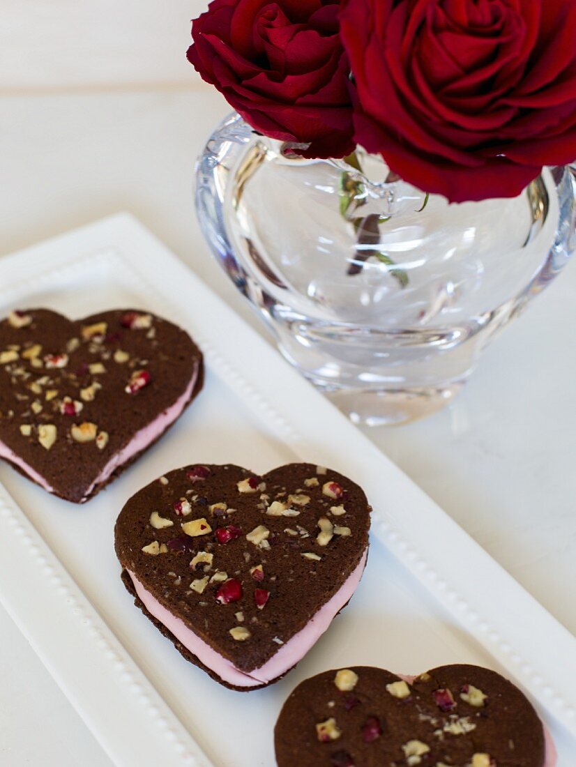 Heart-shaped chocolate biscuits filled with cream for Valentine's Day