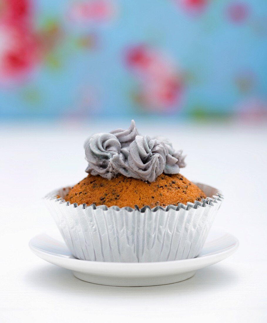 A cupcake topped with grey buttercream
