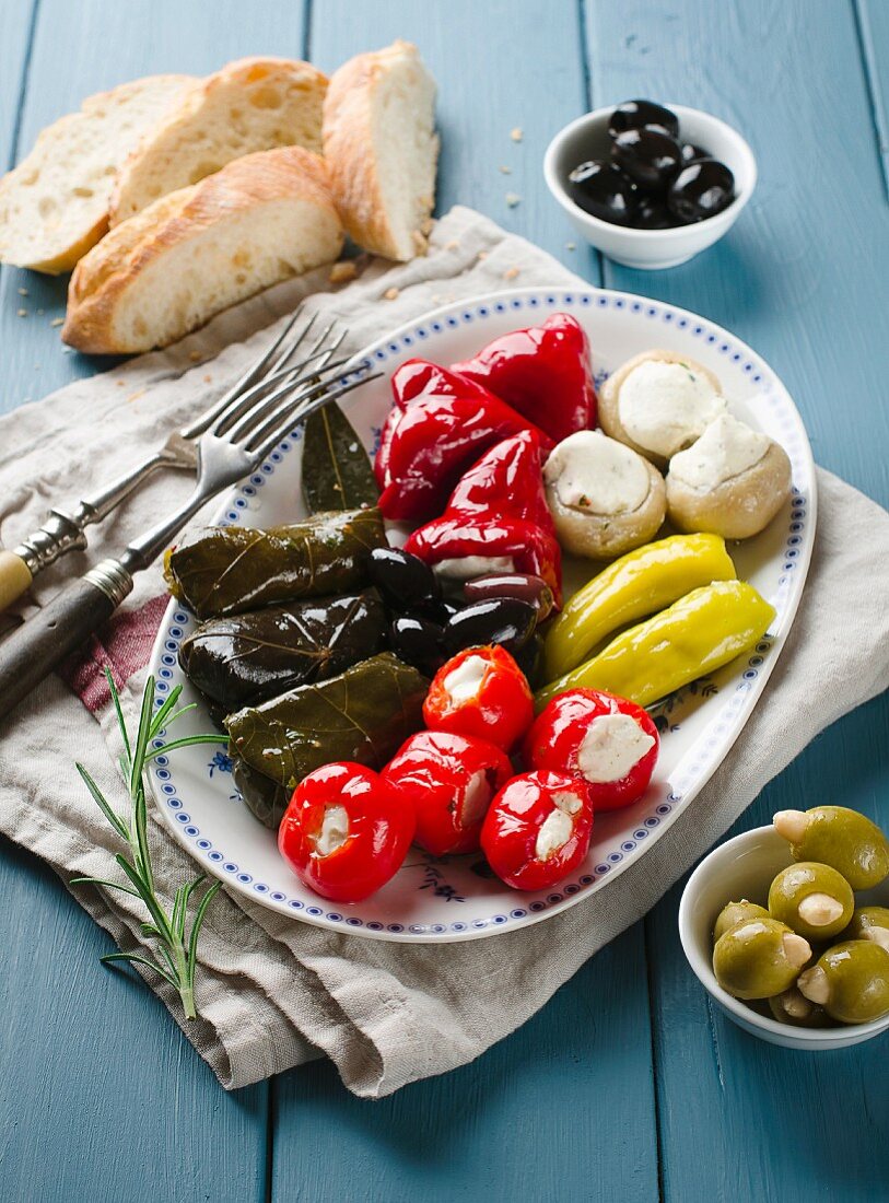 An appetiser platter with stuffed vine leaves and vegetables