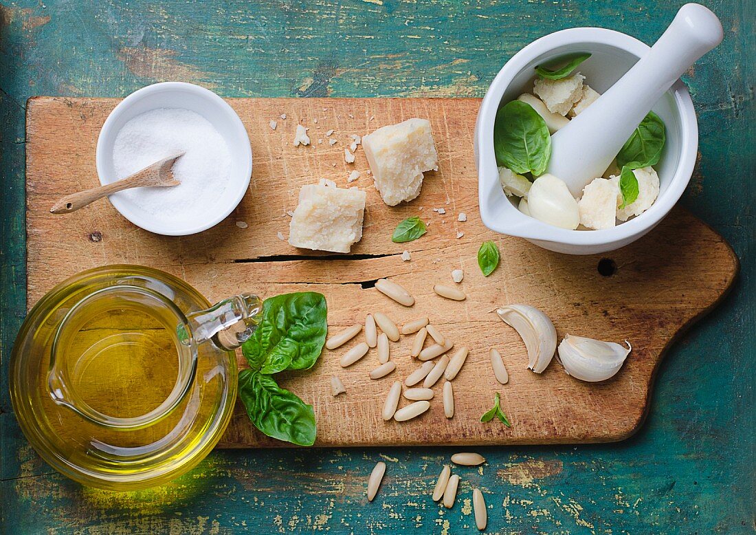 Ingredients for basil pesto on a chopping board
