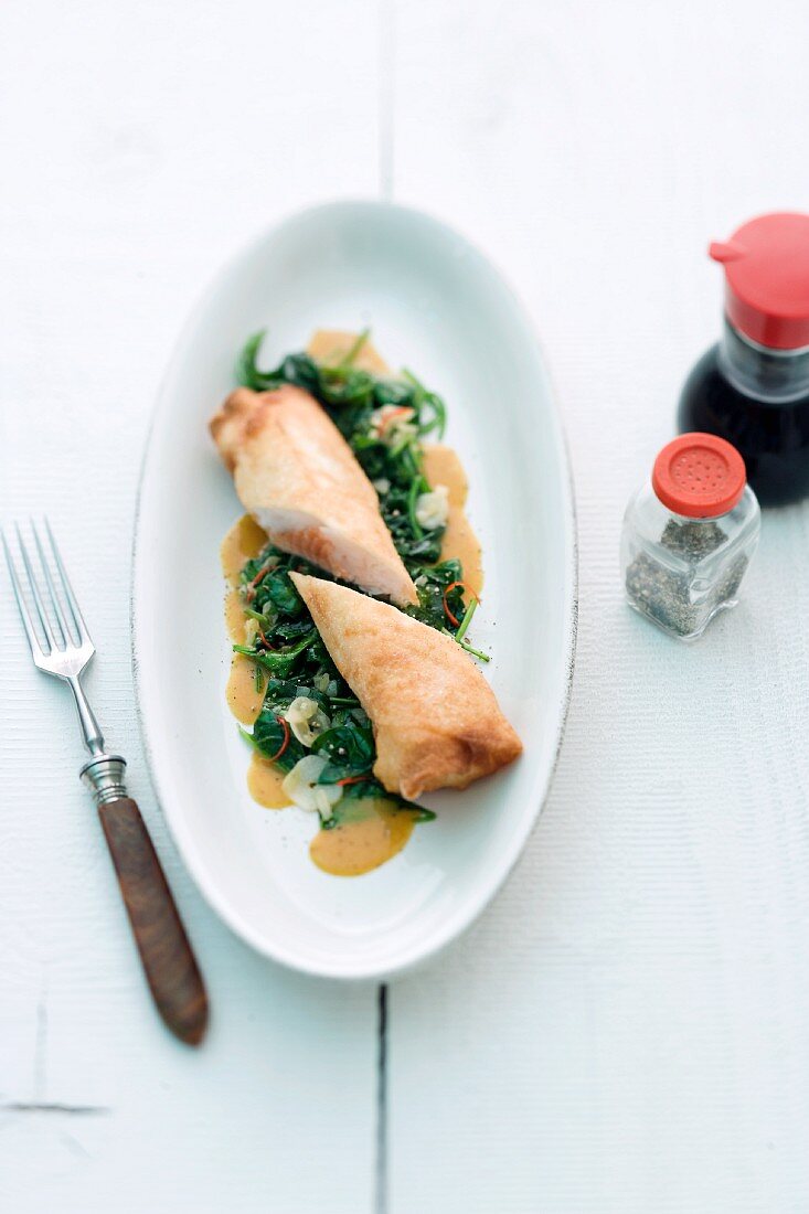 Spring rolls with a salmon filling on a chard medley