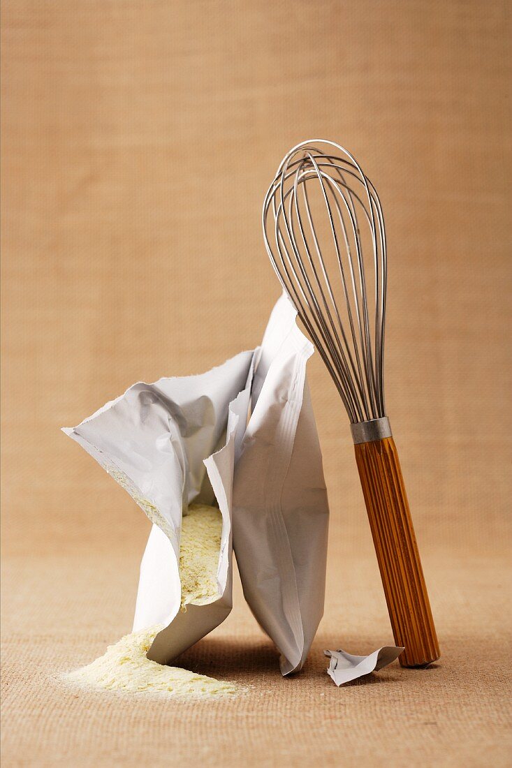 A bag of instant mashed potatoes with a whisk