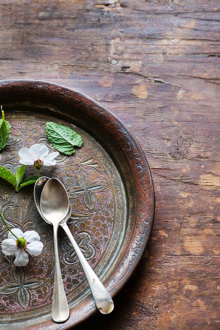 Two teaspoons on a wooden tray