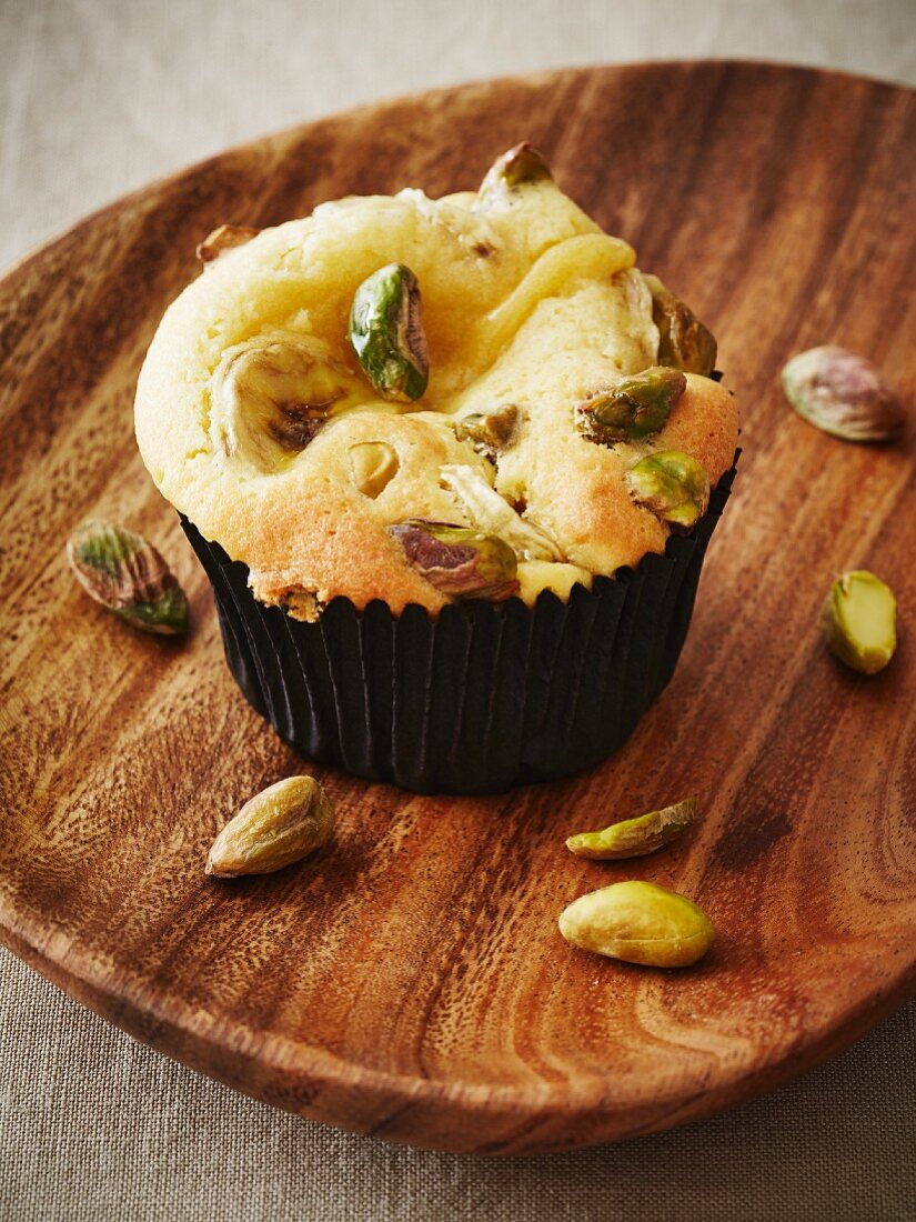 A cupcake with bananas and pistachios
