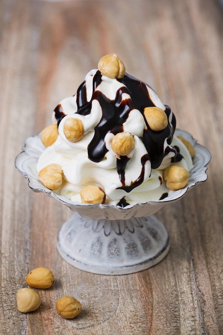 Frozen yogurt with hazelnuts and chocolate sauce