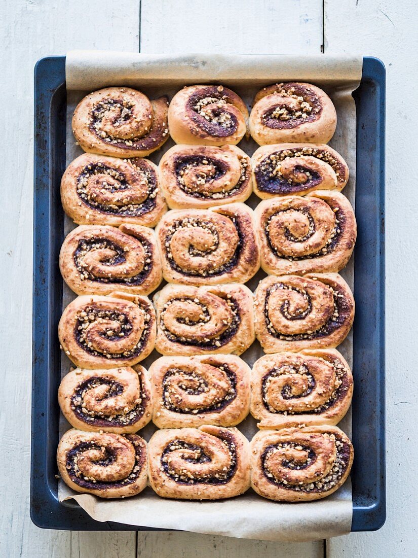 Freshly baked cinnamon rolls on a baking tray