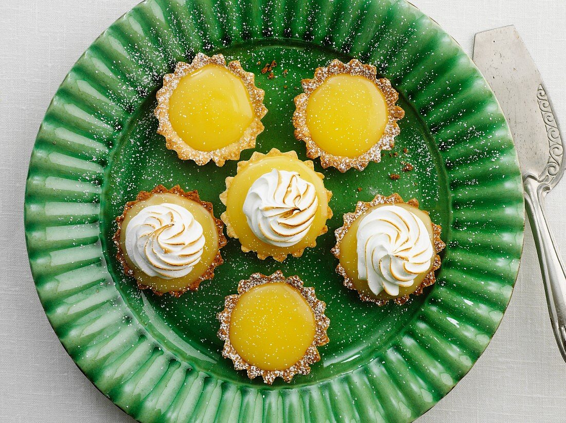 Mini lemon curd and meringue tartlets on a plate