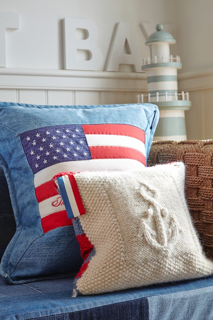 Stars and stripes cushion on sofa with miniature lighthouse in background