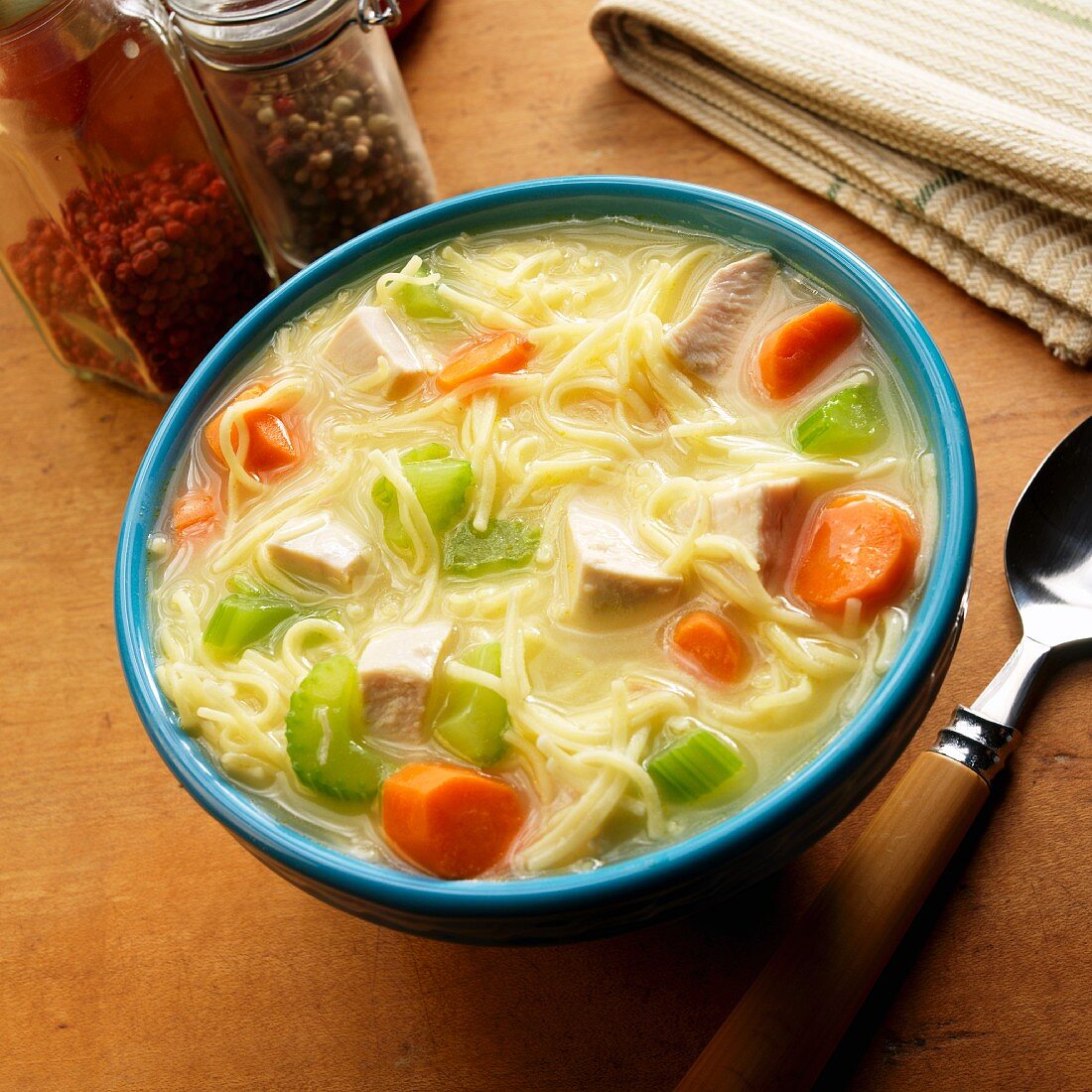 Chicken soup with egg noodles, celery and carrots