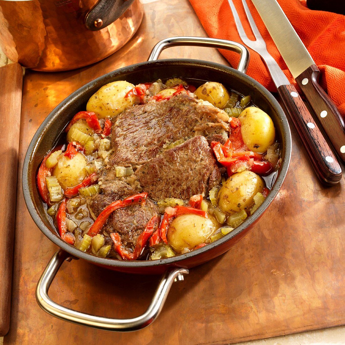 Roast beef with potatoes, peppers, and onions in a pan (Brazil)