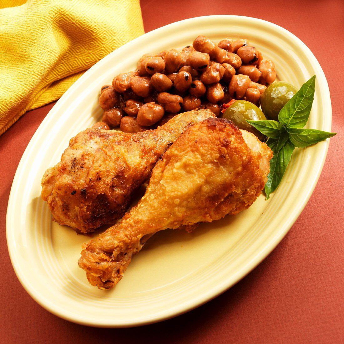 Crispy chicken drumsticks with fava beans and olives (Spain)