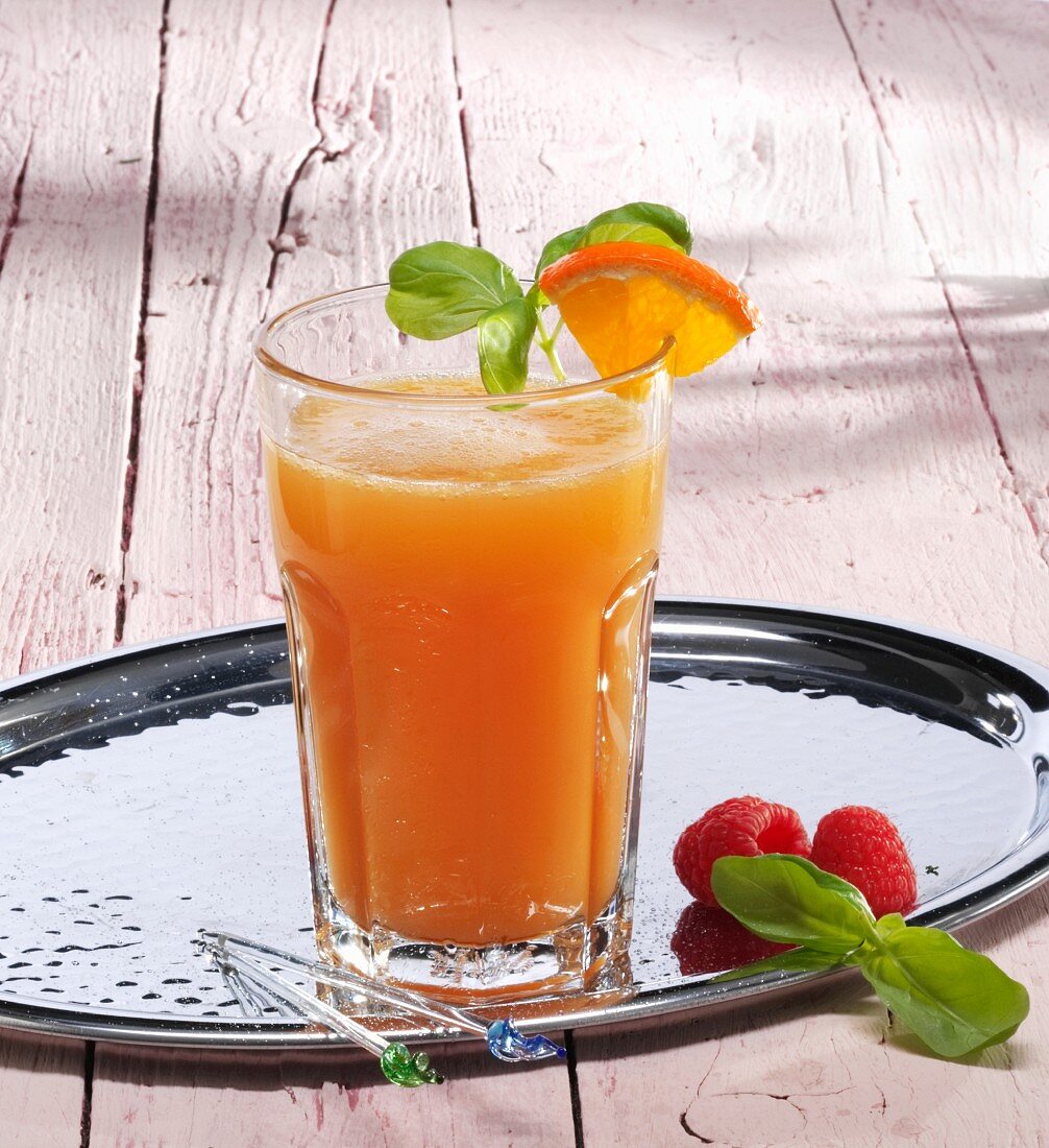 A glass of orange and raspberry lemonade