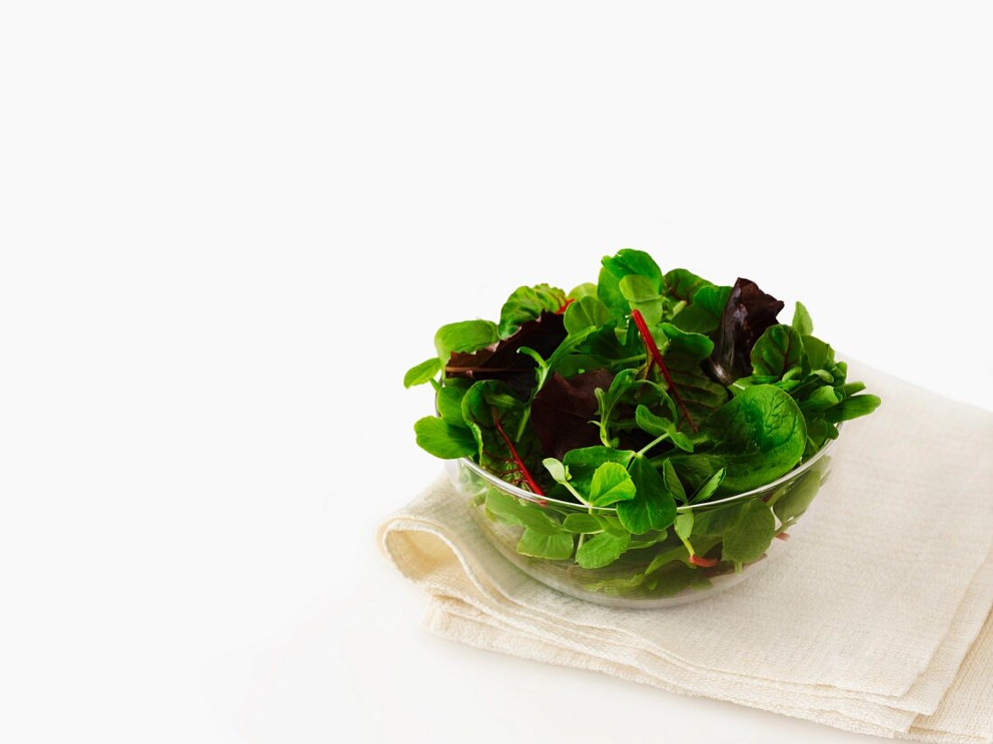 Mixed salad leaves in glass bowl
