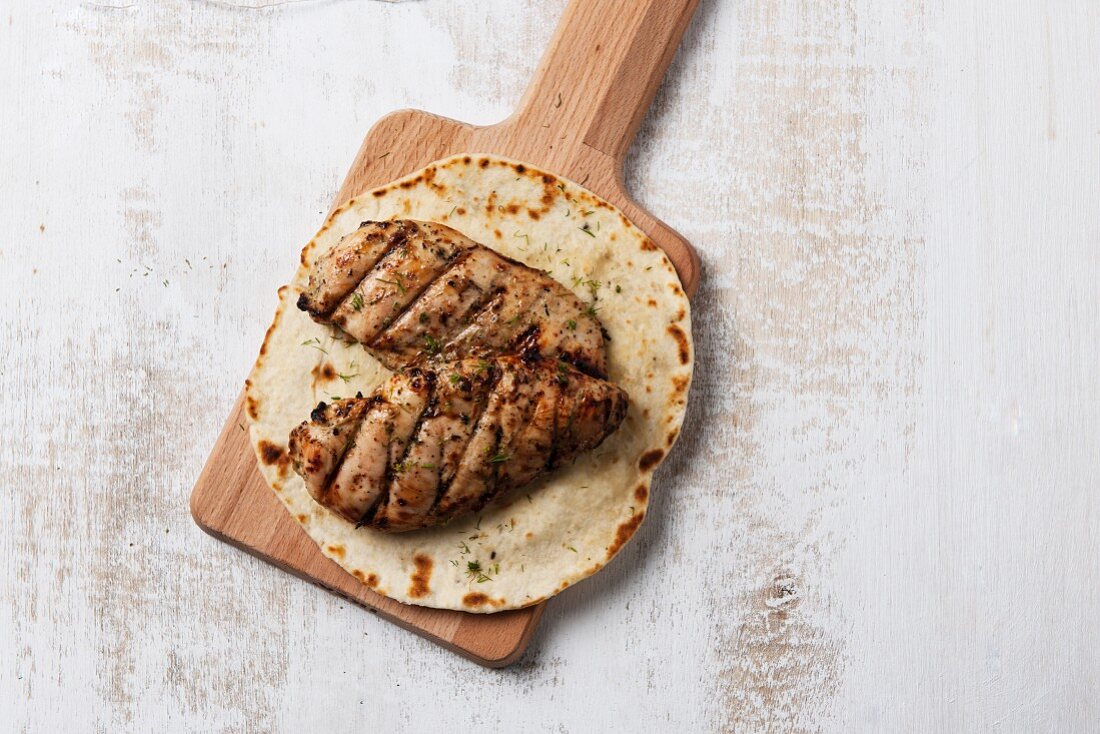 Grilled chicken breast on unleavened bread