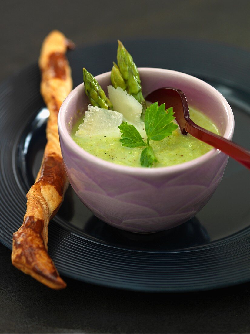 Green asparagus soup with Parmesan and a puff pastry stick