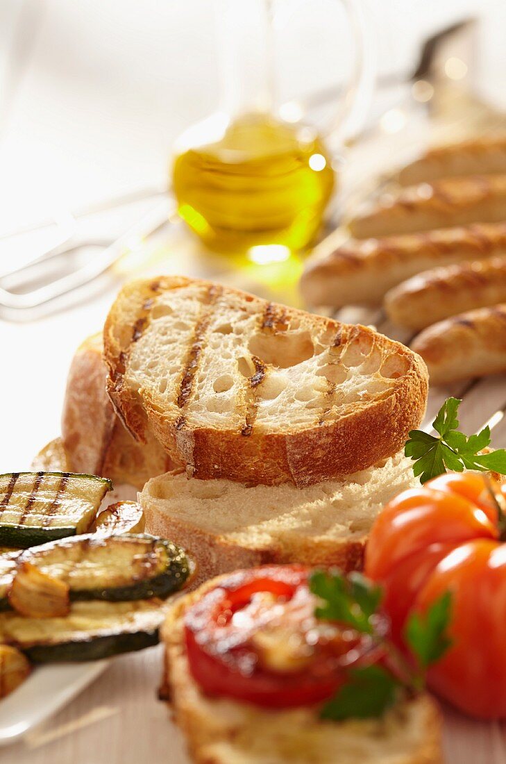 Grilled bread, grilled sausage and olive oil