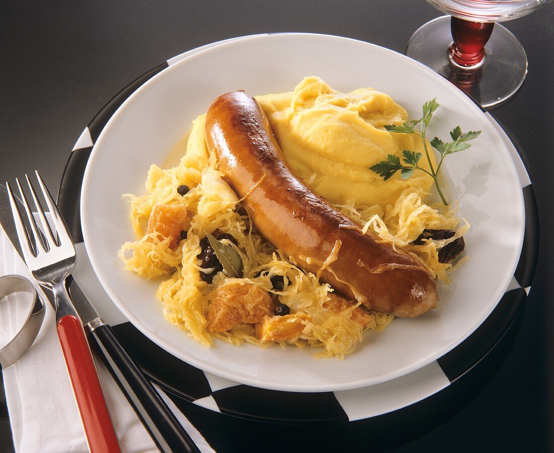 One sausage with mashed potato and sauerkraut