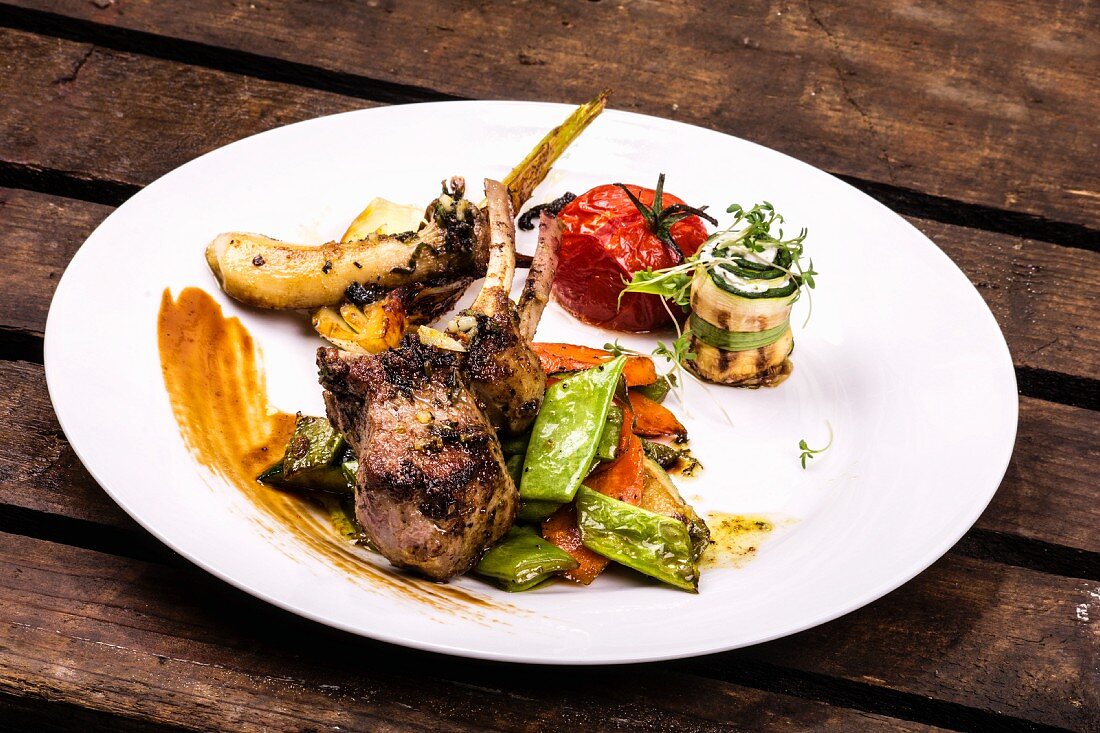 A lamb chop served with Mediterranean vegetables