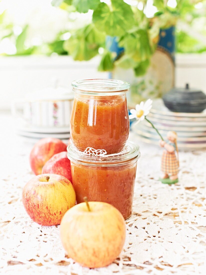 Two jars of apple chutney and fresh apples