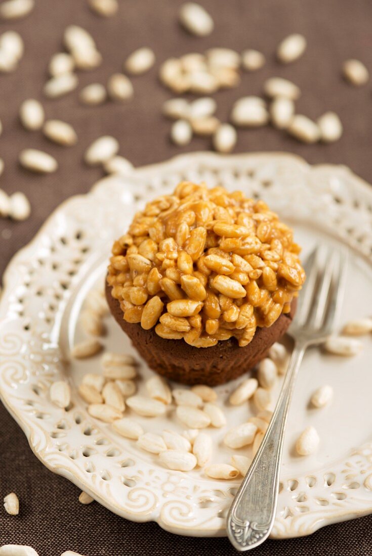 A chocolate cupcake topped with caramelised puffed rice