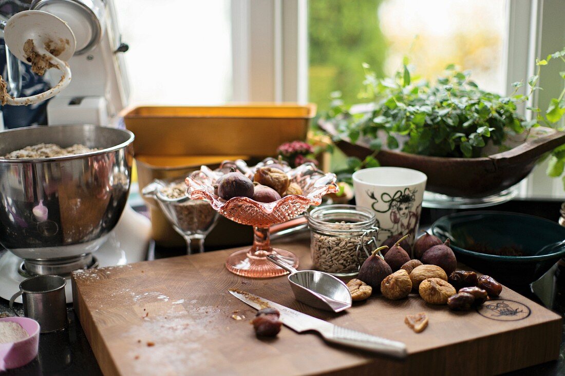 Various breakfast ingredients (roll dough, figs, dates) in a kitchen