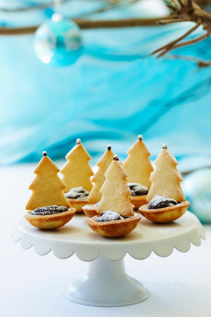 Tartlets decorated with chocolate and Christmas tree biscuits