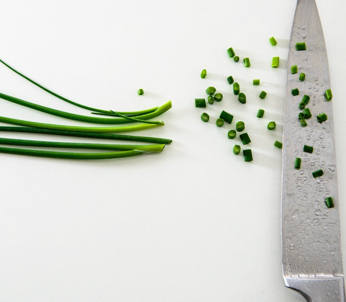 Chopped chives on a knife
