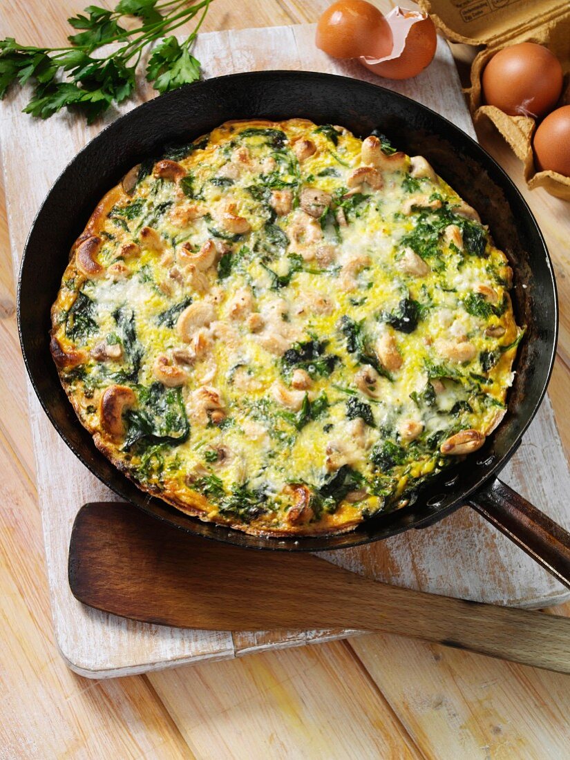 A frittata with spinach, mushrooms and cashew nuts