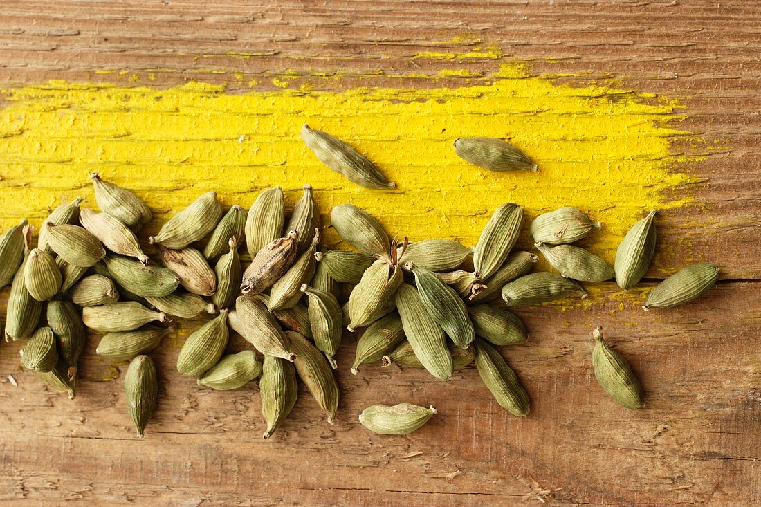 Cardamom pods on wooden background