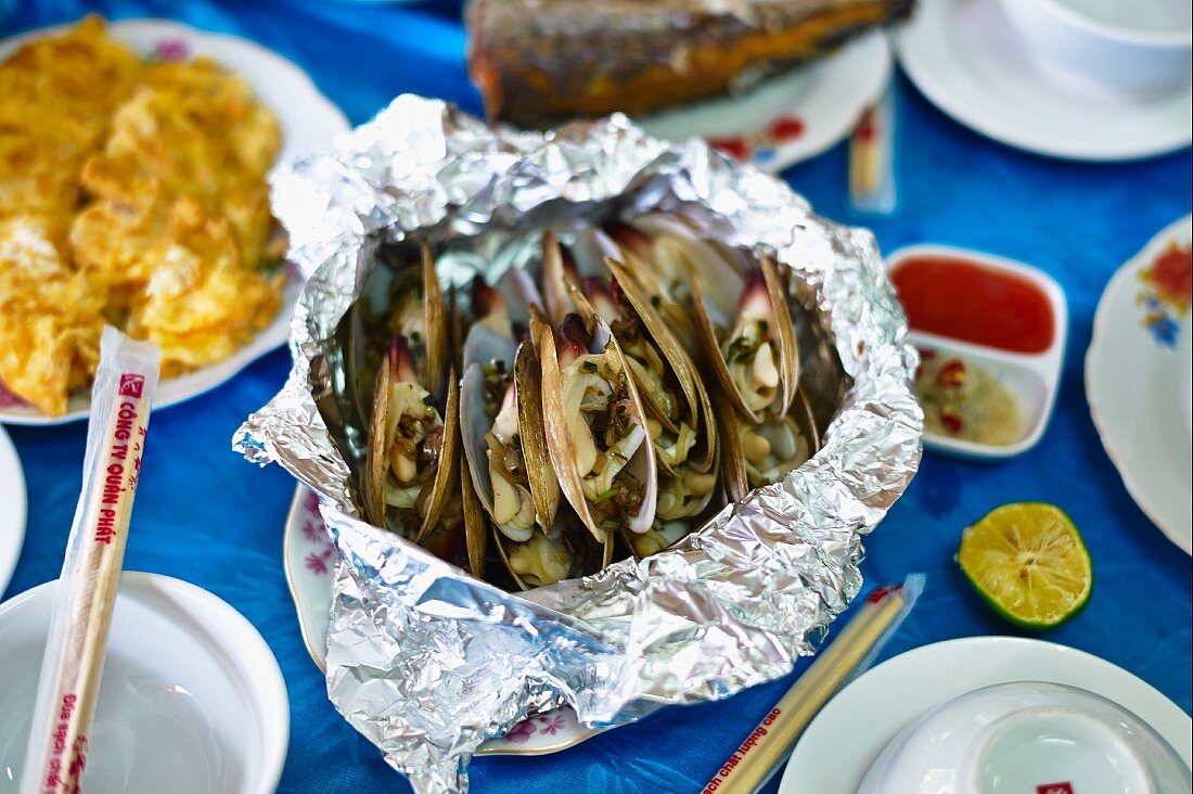 Mekong mussels with vegetables served in aluminium foil